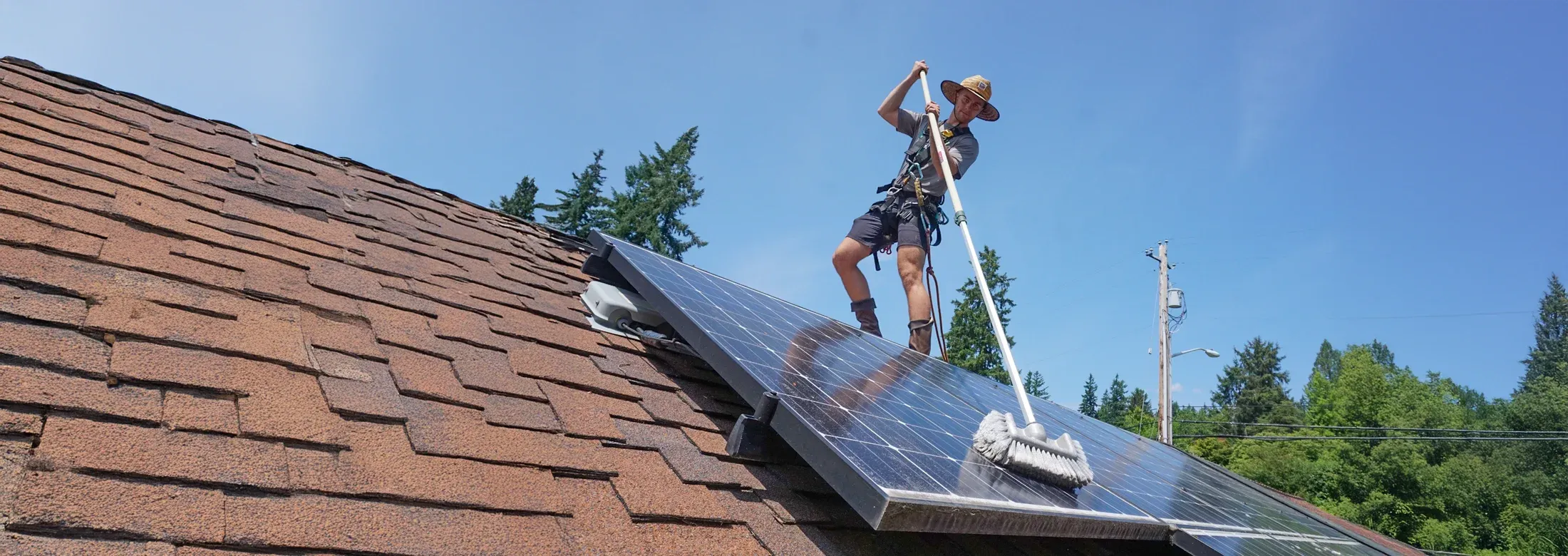 cleaning a solar panel on a roof