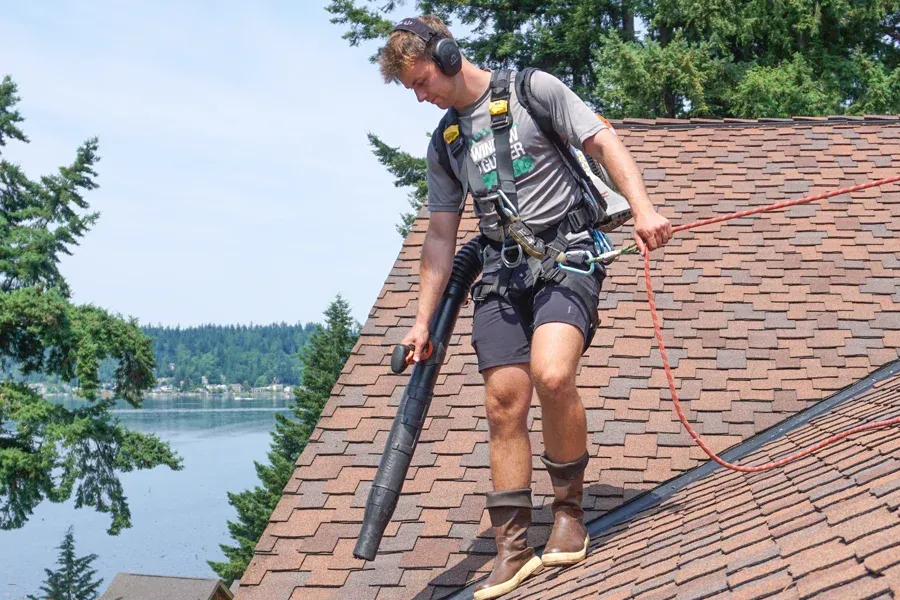 technician cleaning roof